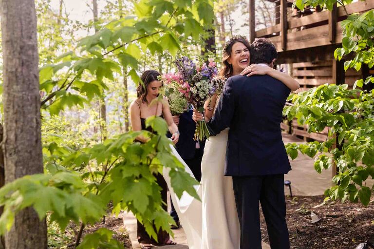 bride and groom hug and share a moment after their wedding ceremony, a moment that a photojournalist who photographs weddings is always looking for