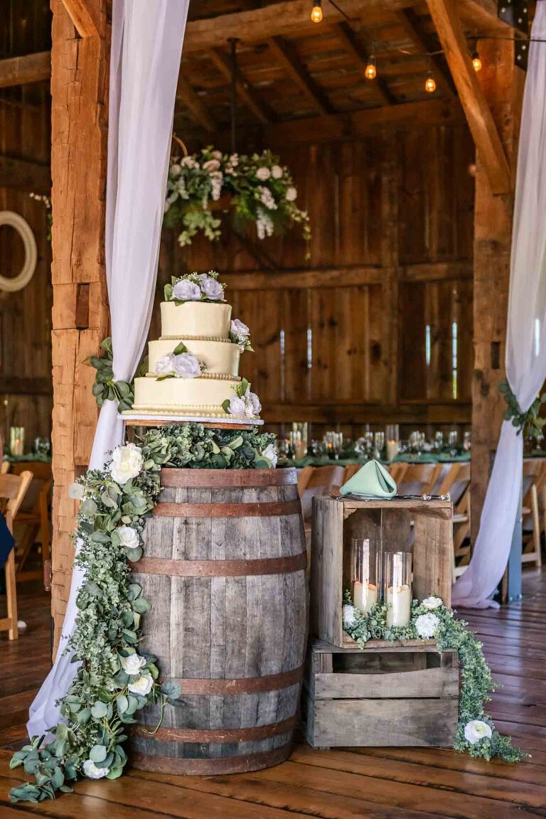 wedding cake and other simple decor displayed at the barn wedding reception venue at pinehall