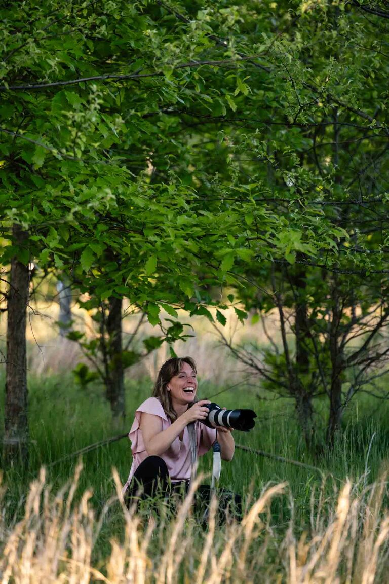 photographer laughing while taking pictures of a bride and groom at their wedding at pinehall farms in butler