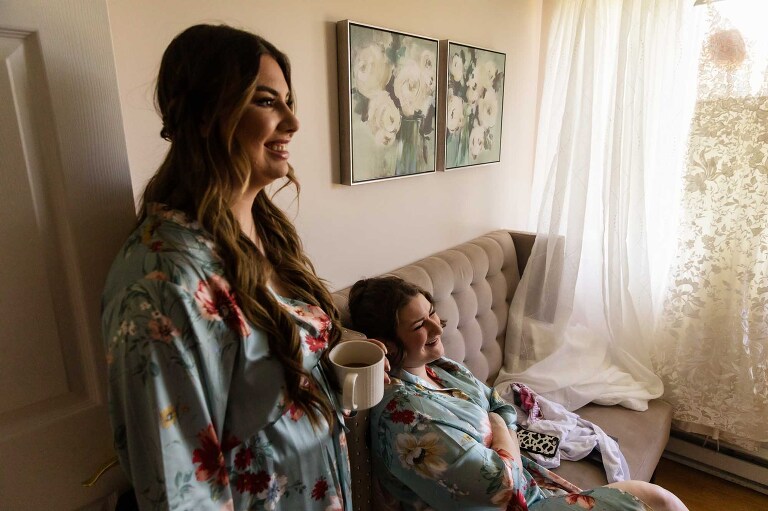 bridesmaids relax and watch the bride get ready for her wedding at pinehall at eisler farms
