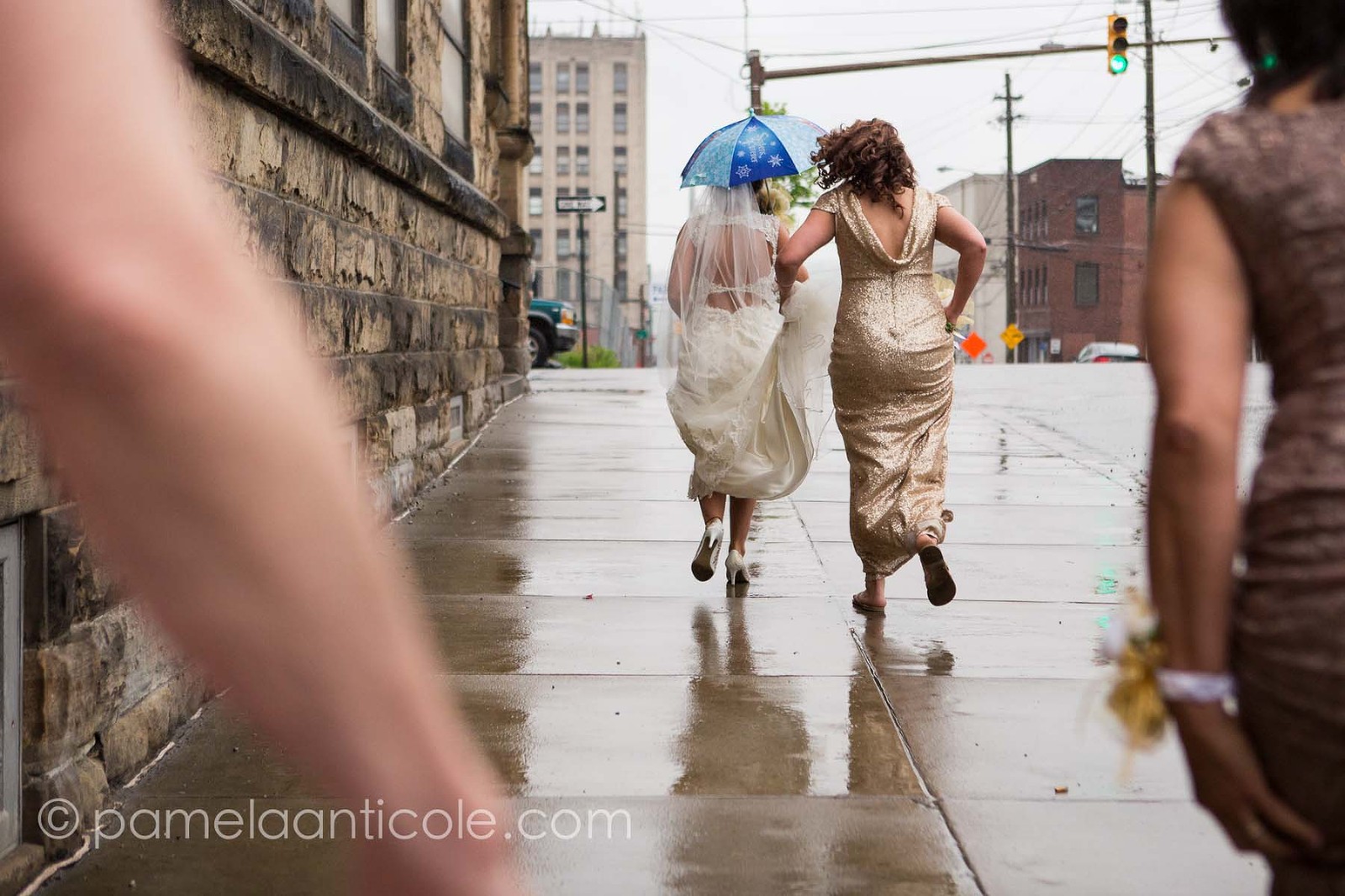 bride running in the rain down the streets of butler pa