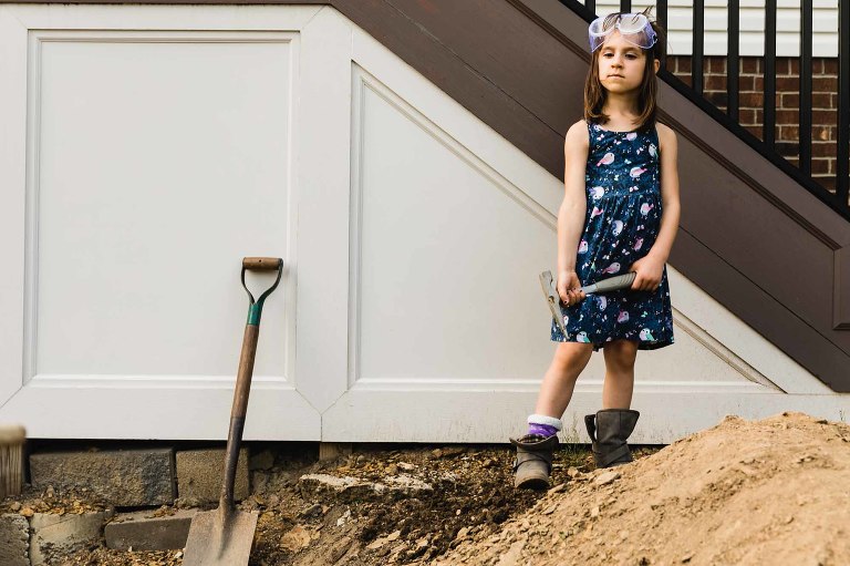 little girl digging a hole