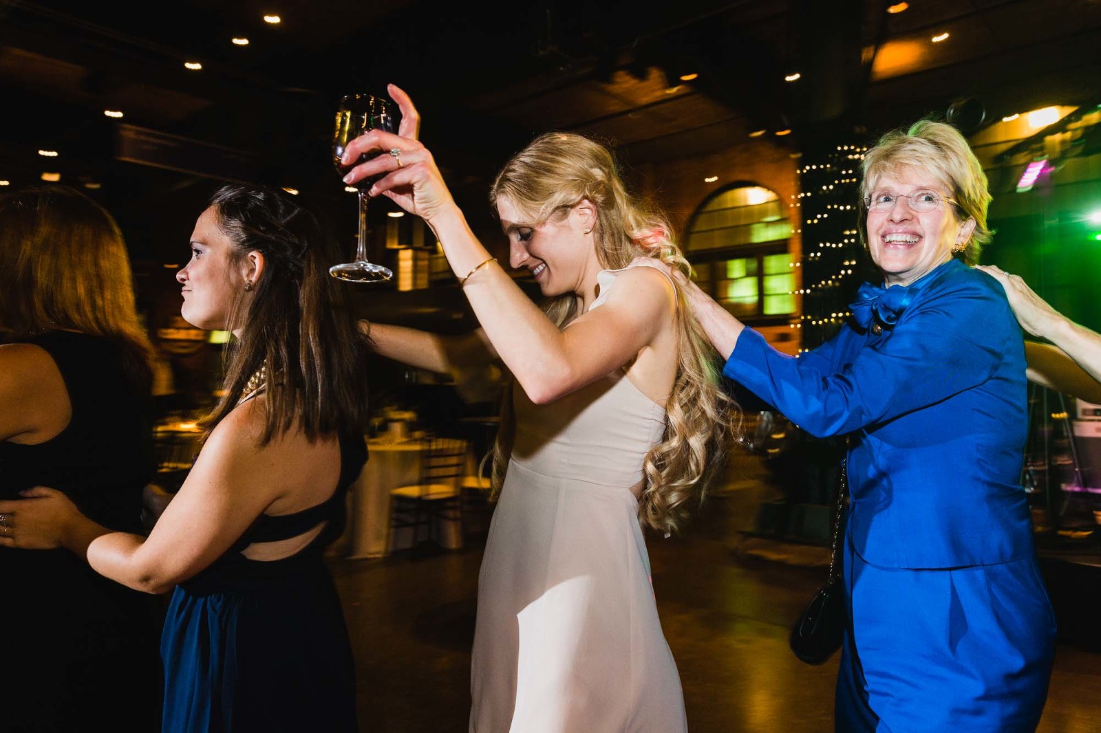 bridesmaids dancing conga line at heinz history center wedding reception in pittsburgh pa