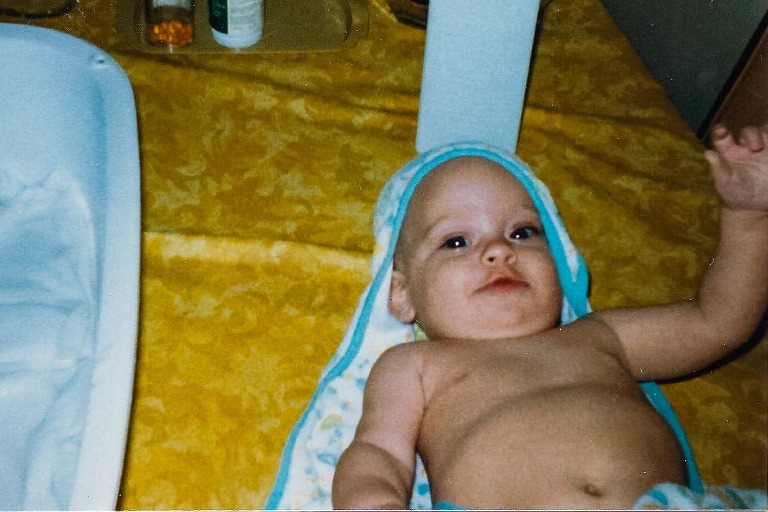 naked baby after bath, 3 months old, laying on blue towel