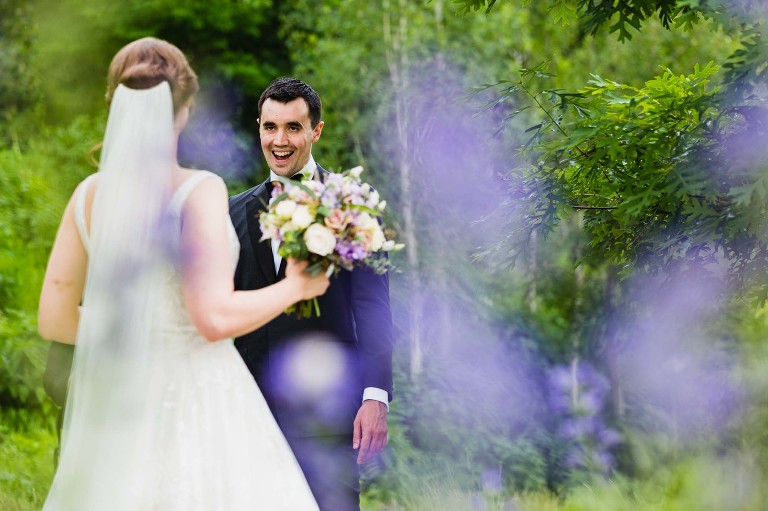 groom gives excited look as he sees his bride for the first time on their wedding day