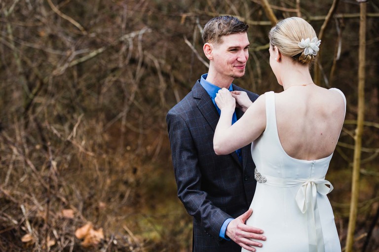 bride fixes groom's tie