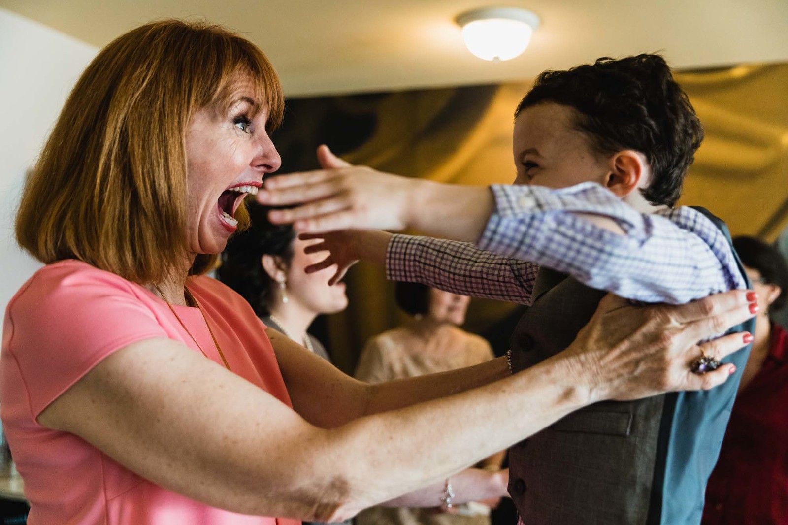 Grandma gives her grandson a big hug, photographed from closeup 