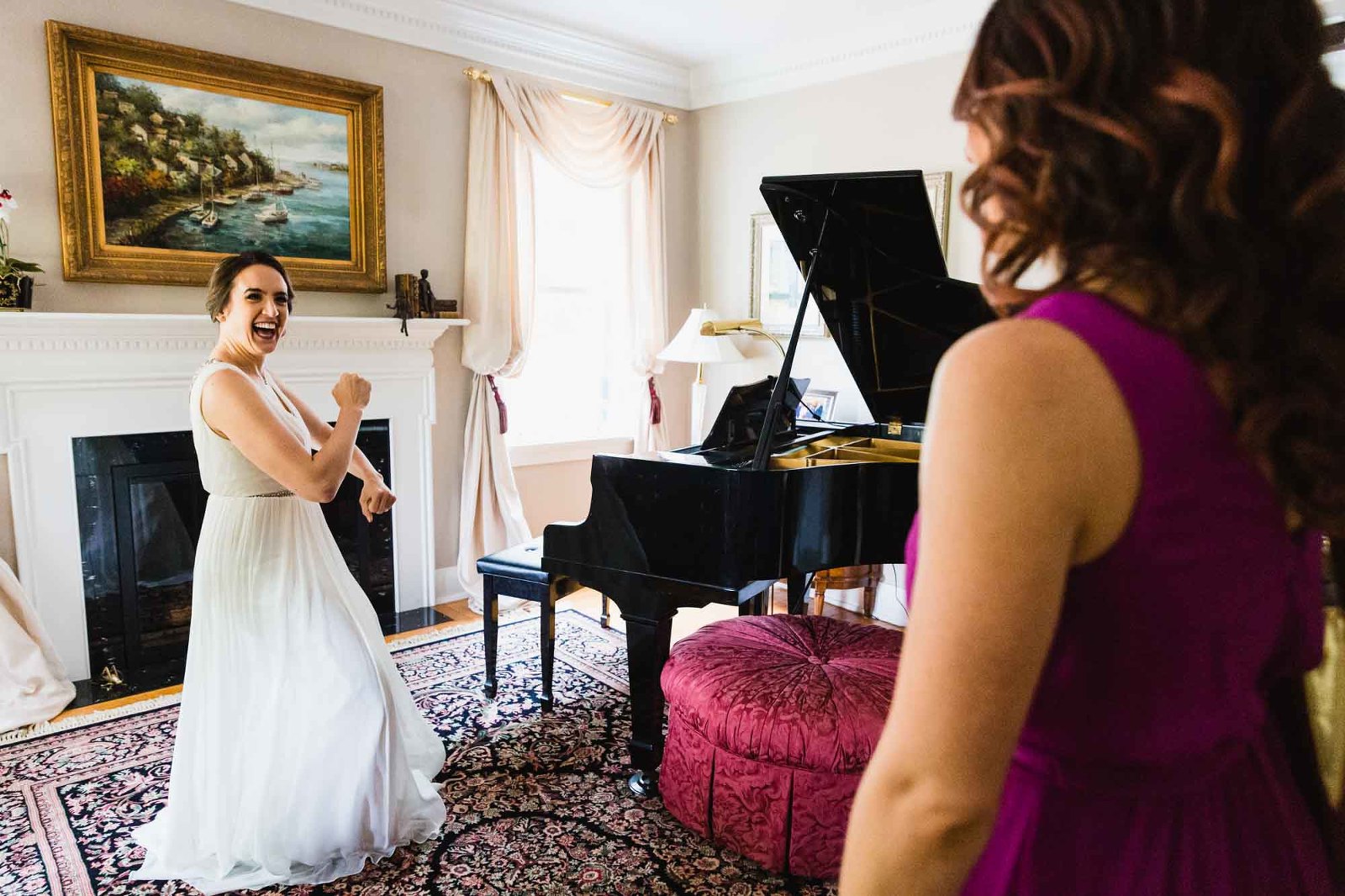 bride dances in front of elegant painting and piano, for her bridesmaids watching her