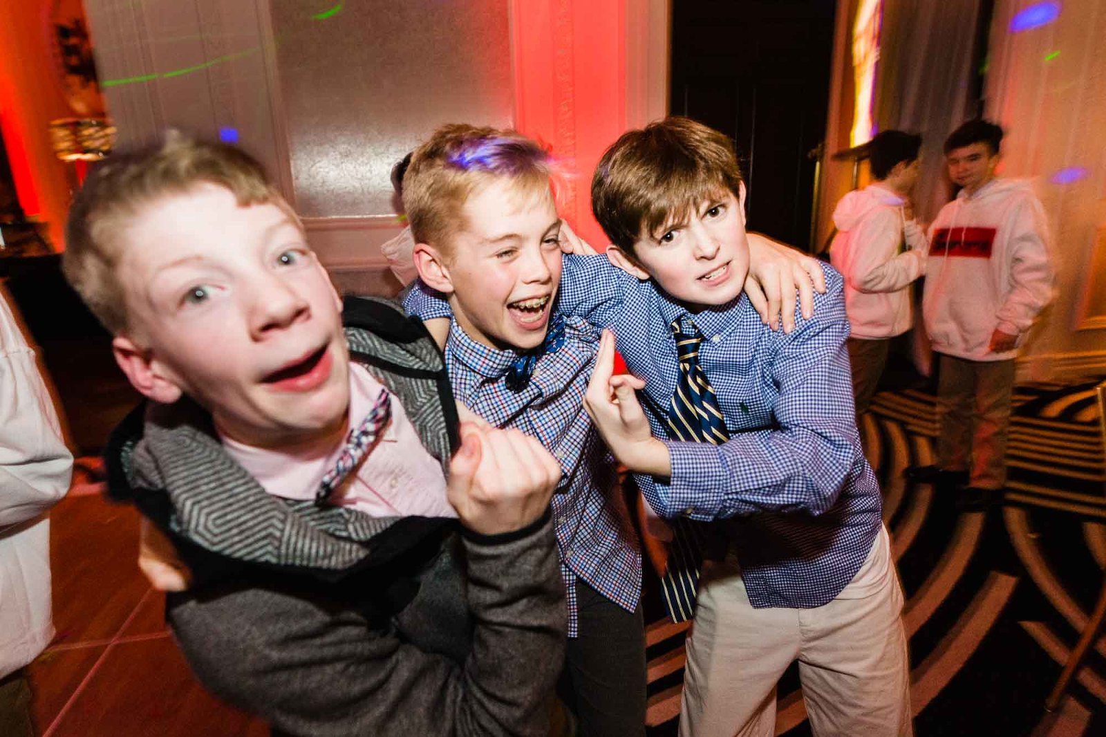 young boys goofing off and laughing for the camera, at a bar mitzvah party at hotel monaco in pittsburgh, pa