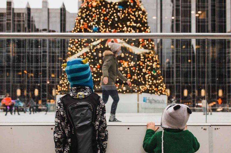 kids watching people skate around the christmas tree at ppg plaza in downtown pittsburgh