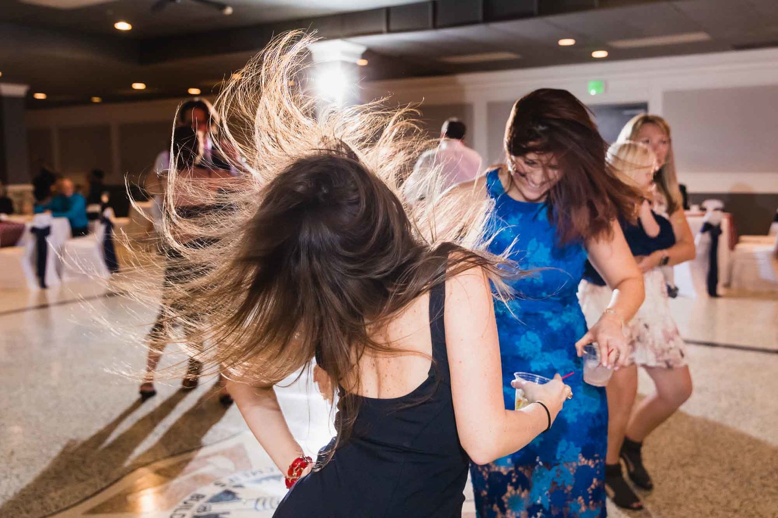 wild dancing at a wedding reception, with girl flipping her hair in the air