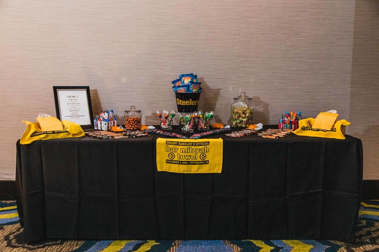 photo of a candy table display in a hotel ballroom, full with black and white candy themed after Pittsburgh sports teams.
