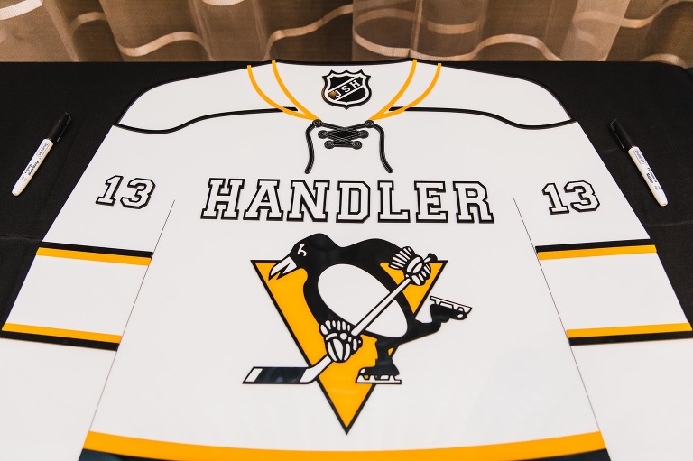 Penguins jersey laid out to sign on a table, with custom name on it