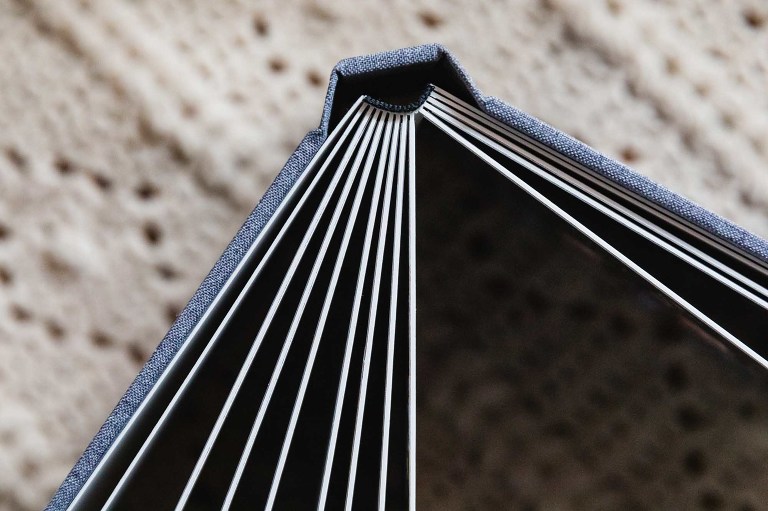 picture of family photo album in a flush mount style, photographed from the side to show the spine wide open