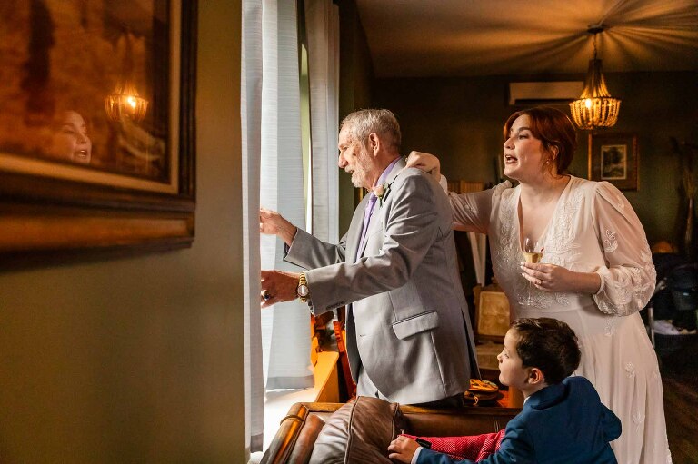 people look out the window as wedding guests arrived, in these WBU Event Venue wedding photos by pittsburgh photographer Pamela Anticole