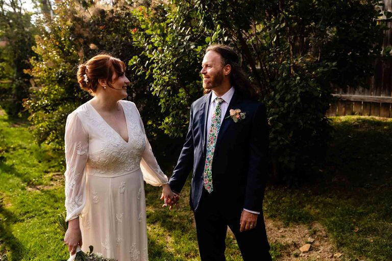 natural portrait of bride and groom holding hands. get your WBU Event Venue wedding photos done all on site!