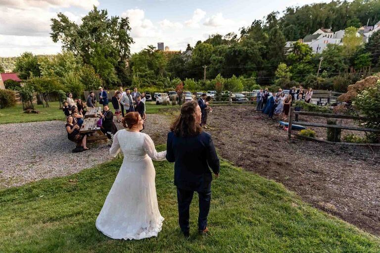 bride and groom walk out and greet their guests at cocktail hour, in WBU Event Venue wedding photos