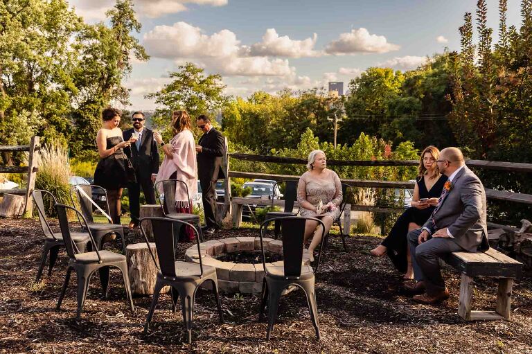 wedding guests mingle on the lawn overlooking downtown pittsburgh, in WBU event center wedding photos