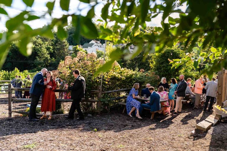 guests chat outdoors in these WBU Event Venue wedding photos, during cocktail hour