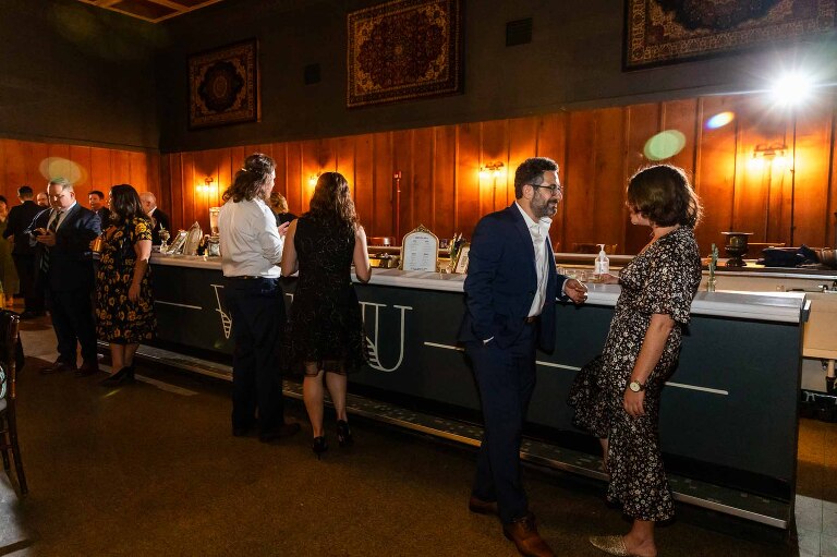 couples at the bar of a wedding reception, pictured in WBU Event Venue wedding photos for Jennie and Adam