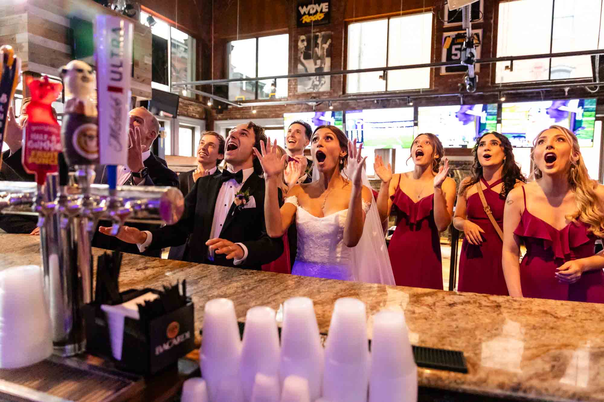 bridal party having fun at their favorite bar, taken by pittsburgh wedding photographer pamela anticole