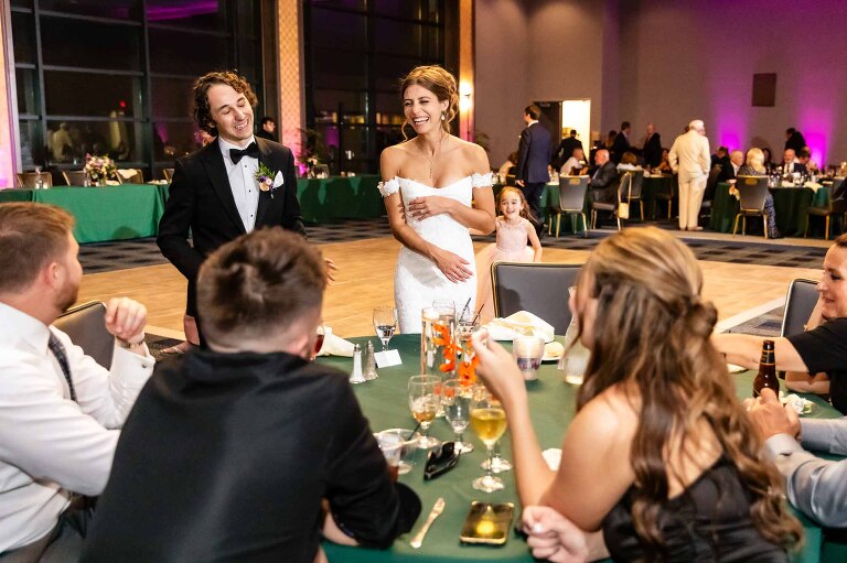 duquesne power center ballroom wedding photos of bride and groom greeting their guests at their reception, in front of the dance floor