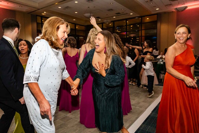 guests dancing and laughing in the duquesne power center ballroom wedding photos taken by pamela anticole, on the dance floor overlooking pittsburgh