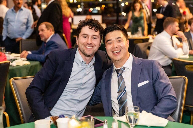 wedding pictures of guests at a duquesne power center wedding, showing the ballroom in the background overlooking the city of pittsburgh