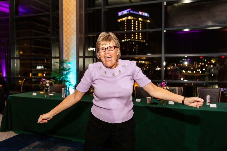 wedding guest dancing in front of the downtown skyline viewable through the windows at the duquesne power center ballroom
