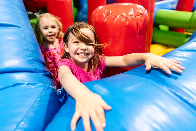 the most unique location for family photos in pittsburgh might be your kid's favorite spot. this little girl wanted to do her family photos at the bouncy house where they spent lots of time together! afterward we got portraits outside by a colorful wall. 