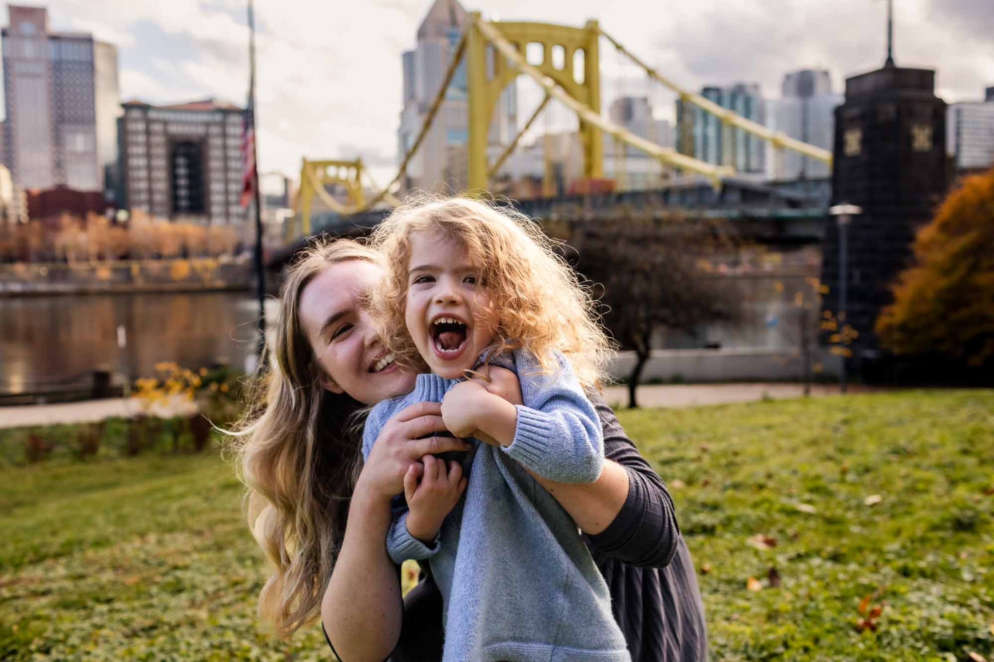 A family photographer, Pamela Anticole gives pittsburgh families beautiful candid professional family photos throughout the pittsburgh area- including in front of the iconic yellow bridges as pictured here!