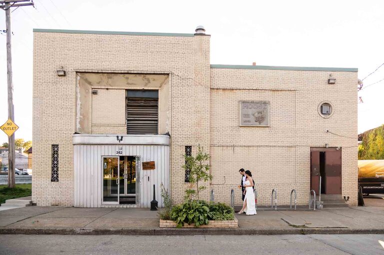 bride and groom walking in front of one of the most unique wedding venues in pittsburgh, spirit located in the heart of lawrenceville