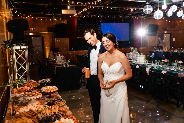 bride and groom sees the cookie table at their wedding at spirit pittsburgh
