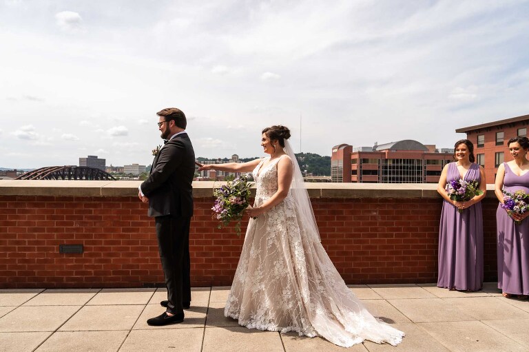 first look on the balcony at the heinz history center wedding venue, outside the mueller center. candid pictures taken by pittsburgh wedding photographer pamela anticole