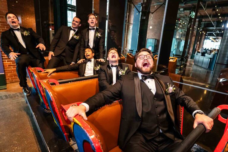 groomsmen acting silly on the kennywood roller coaster car at the heinz history center, for their wedding photos there.