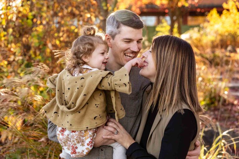 fall mini sessions in pittsburgh, family playing together in front of fall foliage