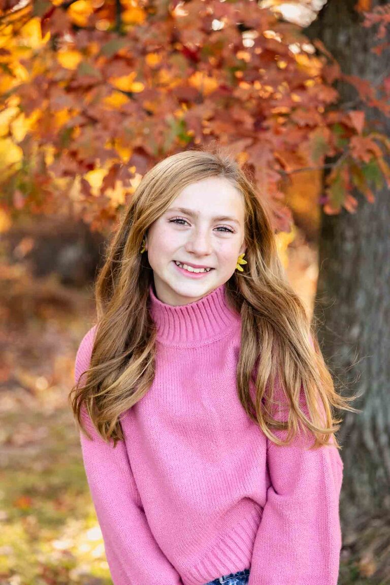 young family with two boys standing amongst tall trees at sunset, emotionally connecting