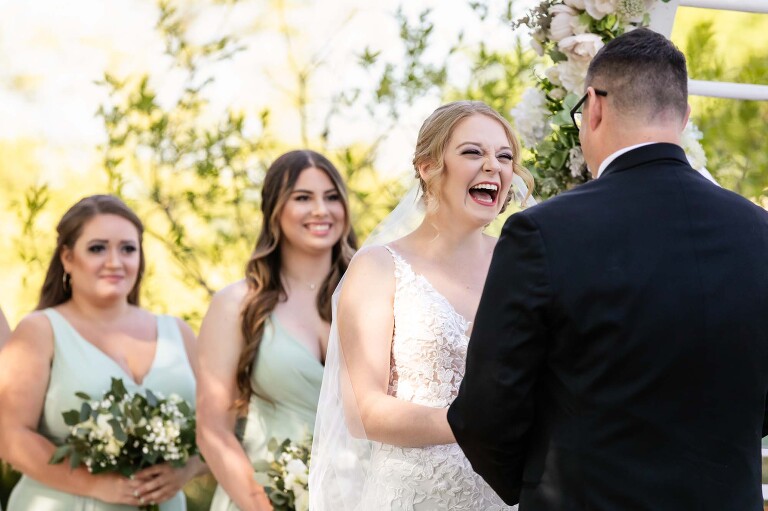 bride and groom laugh together during their wedding ceremony at pinehall at eisler farms