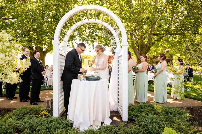 bride and groom plant a tree together in honor of their marriage