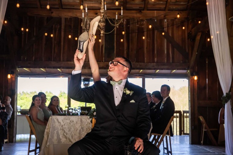 bride and groom played the shoe game at their barn wedding at pinehall at eisler farms