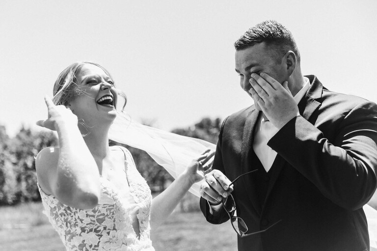 black and white picture of bride and groom laughing and crying during their first look at pinehall at eisler farms