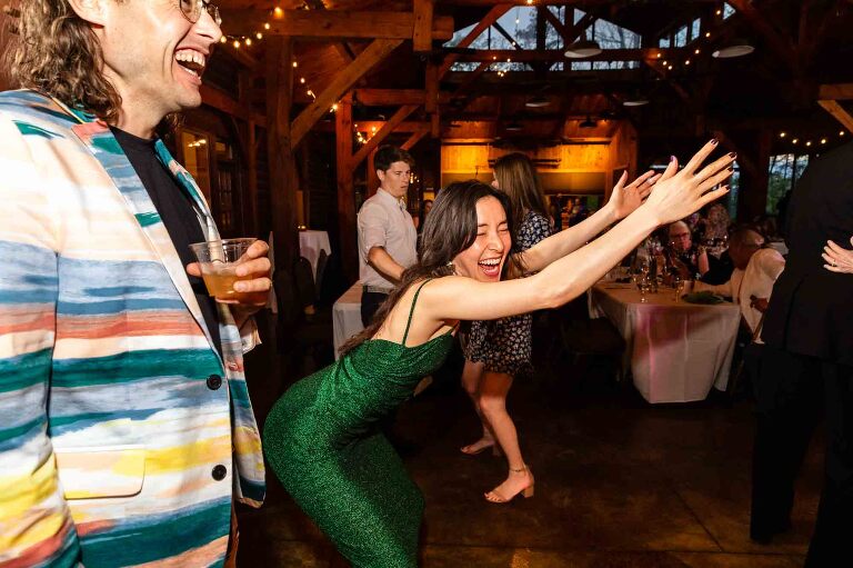 Candid moment of guests laughing during cocktail hour at Adventures on the Gorge wedding